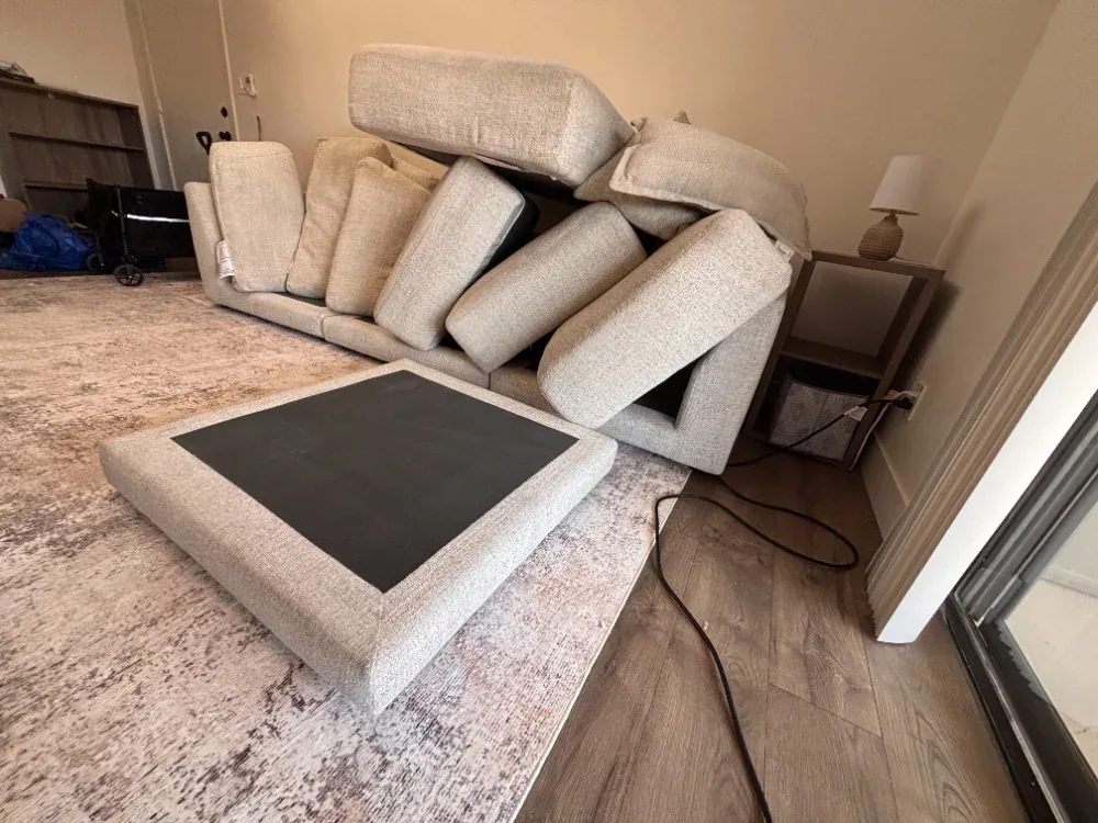Sofa with every cushion removed and stood on end during cleaning